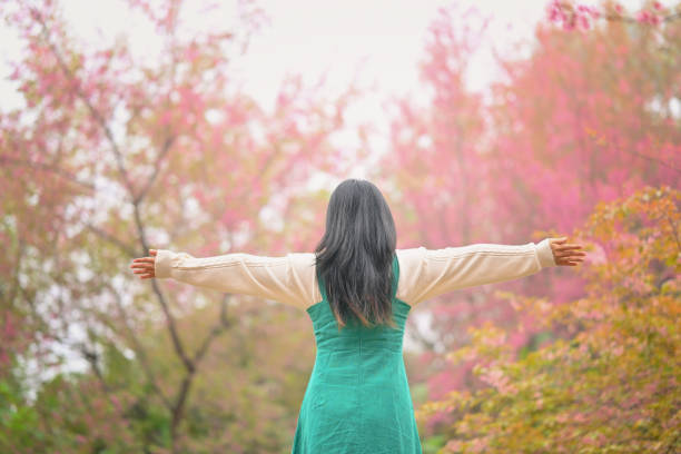 Woman standing with her arms streched out wide